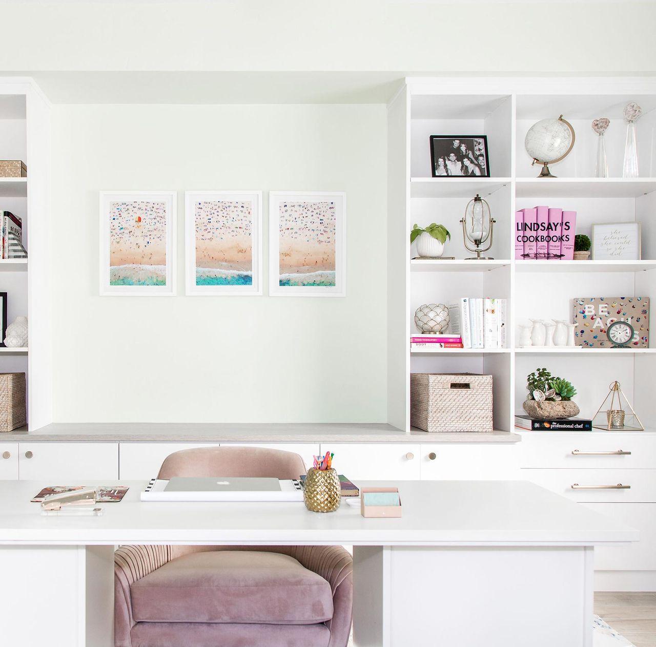 Office designed in crisp white matte finish with custom shelving, cabinets, counterspace and desk by California Closets