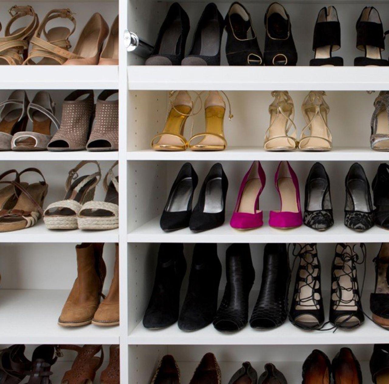 Custom white wood grain finish shoe racks created by California Closets