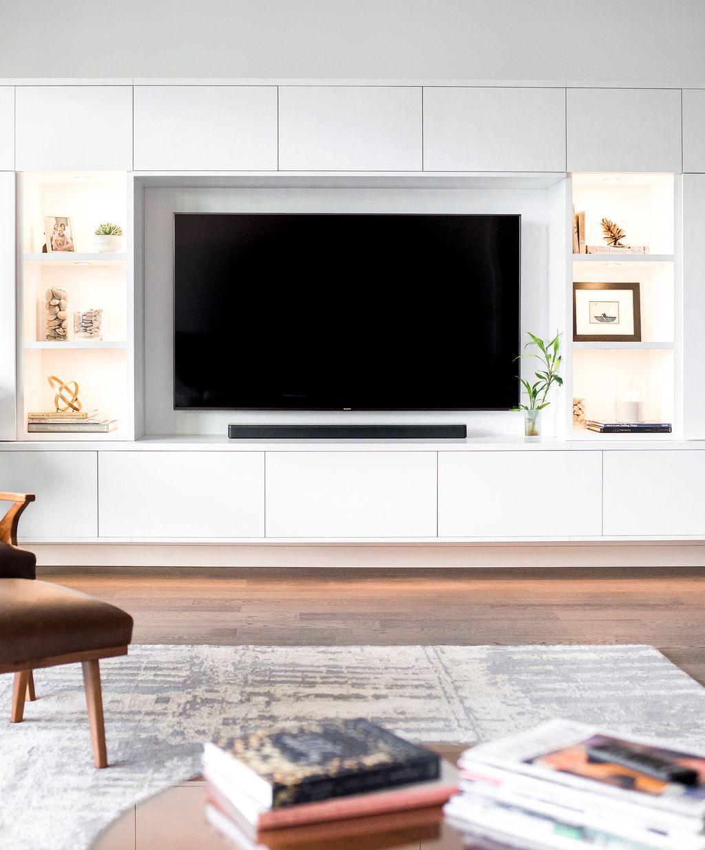 Modern-styled entertainment center design with custom cabinets and shelves from California Closets