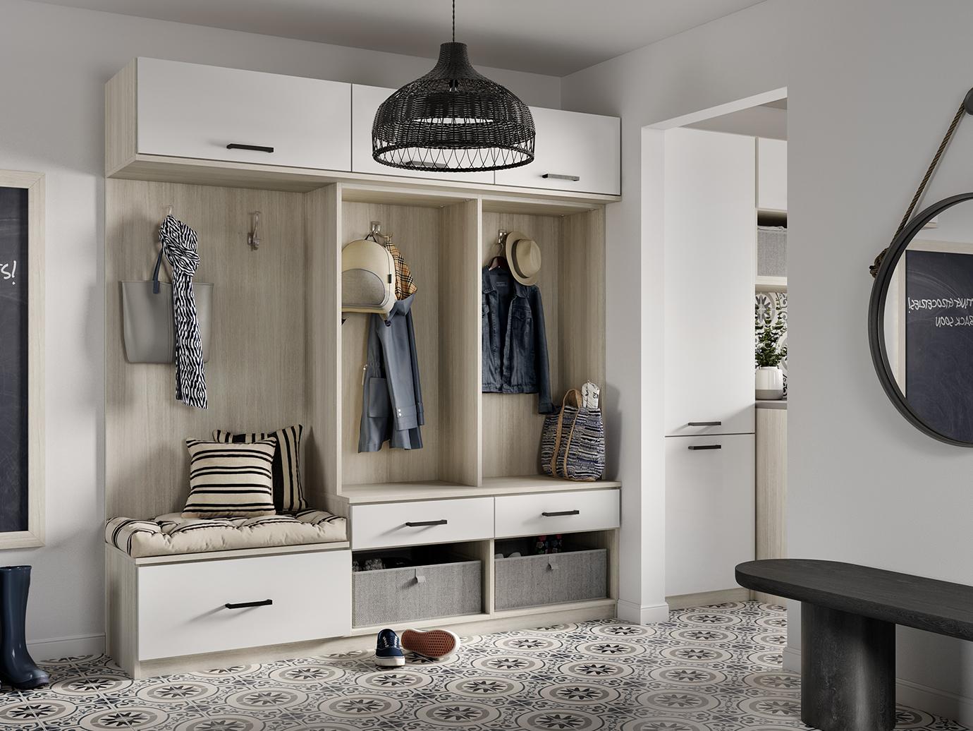 Mudroom and entryway design with storage cabinets and bench in white finish by California Closets