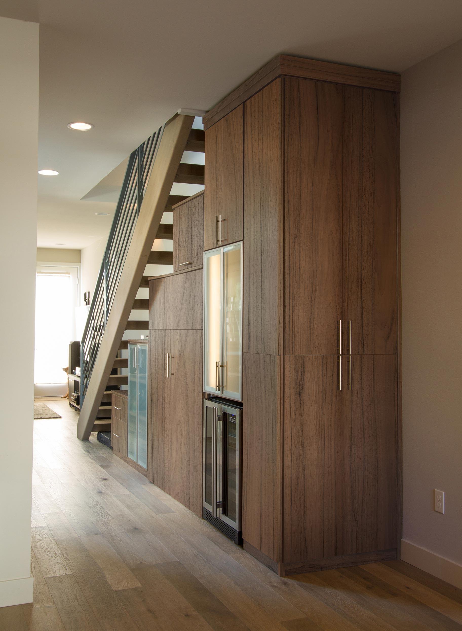 Understairs pantry closet designed with hidden drawers by California Closets