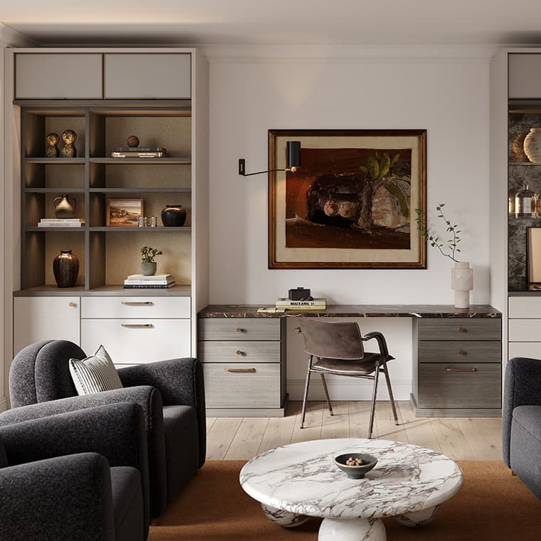 A stylish home office featuring built-in shelves flanking a marble-topped desk, decorated with books, vases, and art. The space includes a brown leather chair, two dark gray armchairs, and a round marble coffee table.