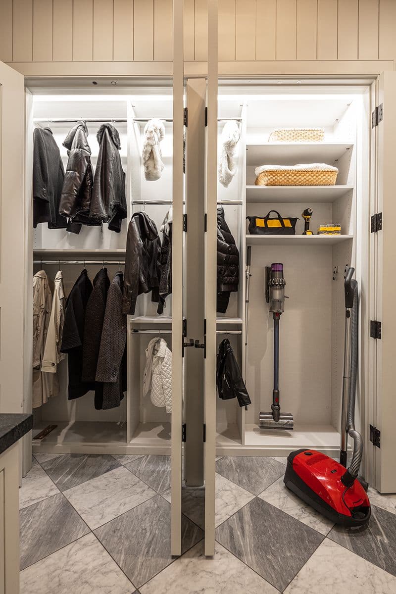 Side by side mudroom and utility closet storage in light finish by California Closets. Activate to enhance image.
