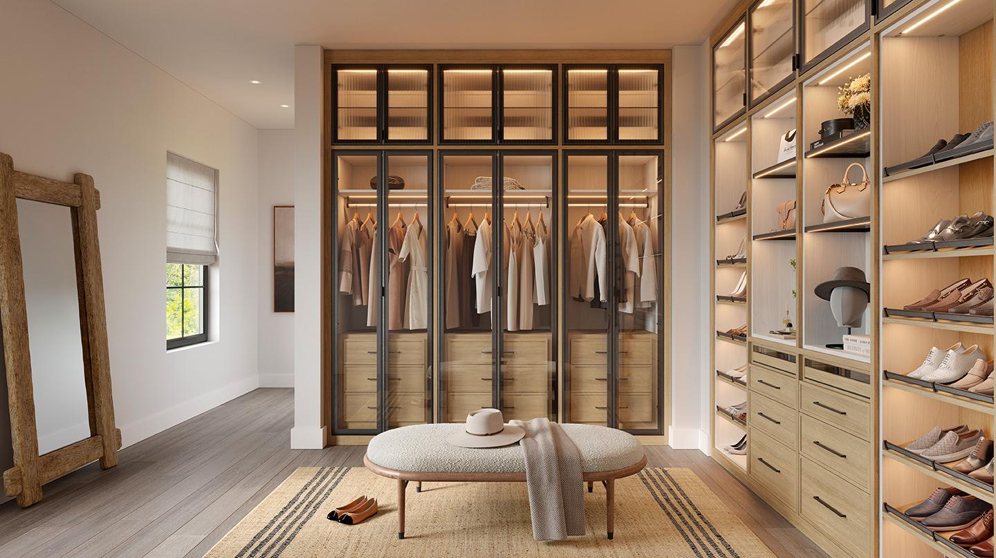 A walk in closet design with custom shoe racks, shelving, drawers and LED lighting envisioned by California Closets