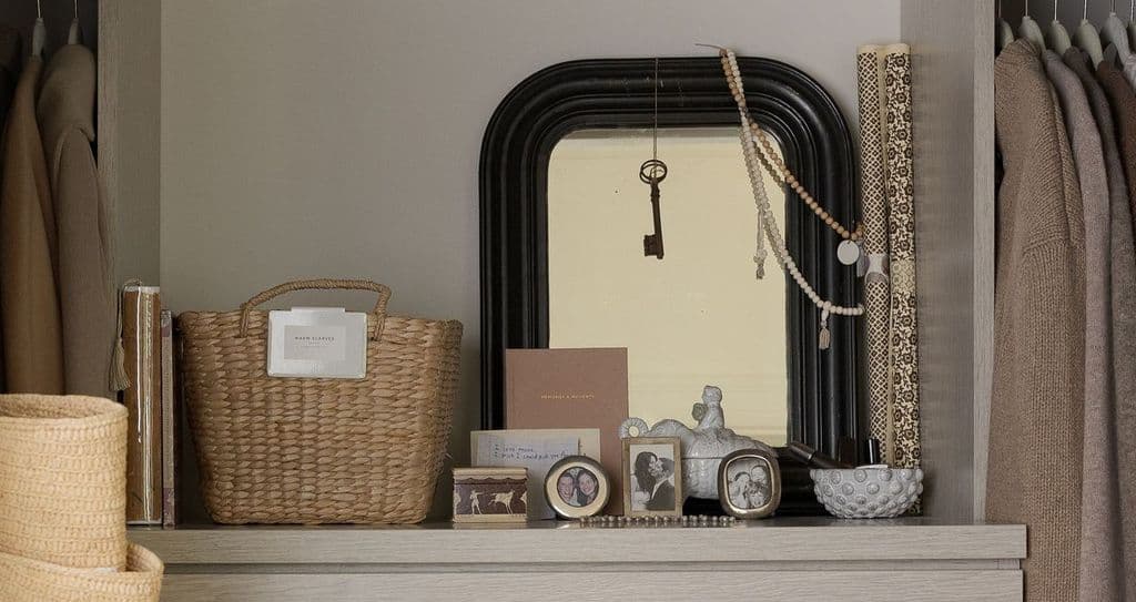Customized shelf in walk in closet designed in light finish by California Closets