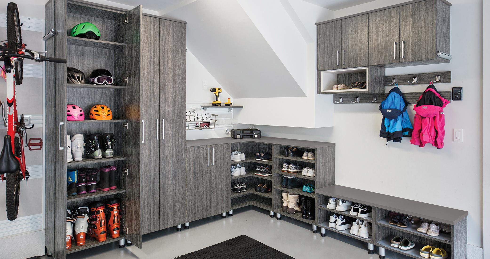 Custom solution for the garage complete with shoe and boot storage by California Closets