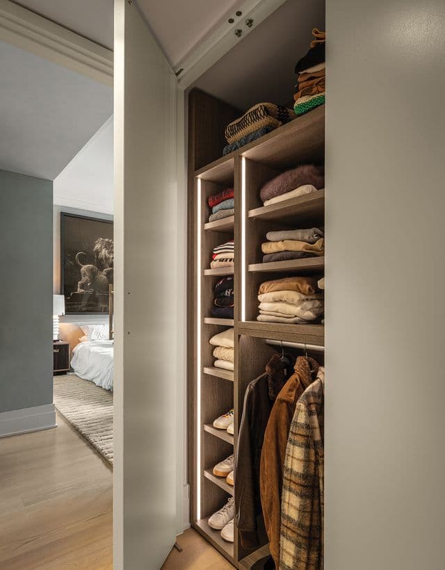 Closet in the hallway used for folded sweaters, created in a light finish by California Closets