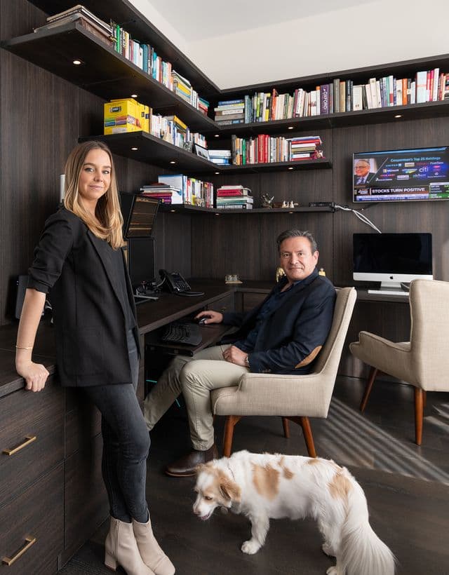 Kathy Cesar Garcia in a custom home office designed with dark finish desks, drawers and cabinets by California Closets