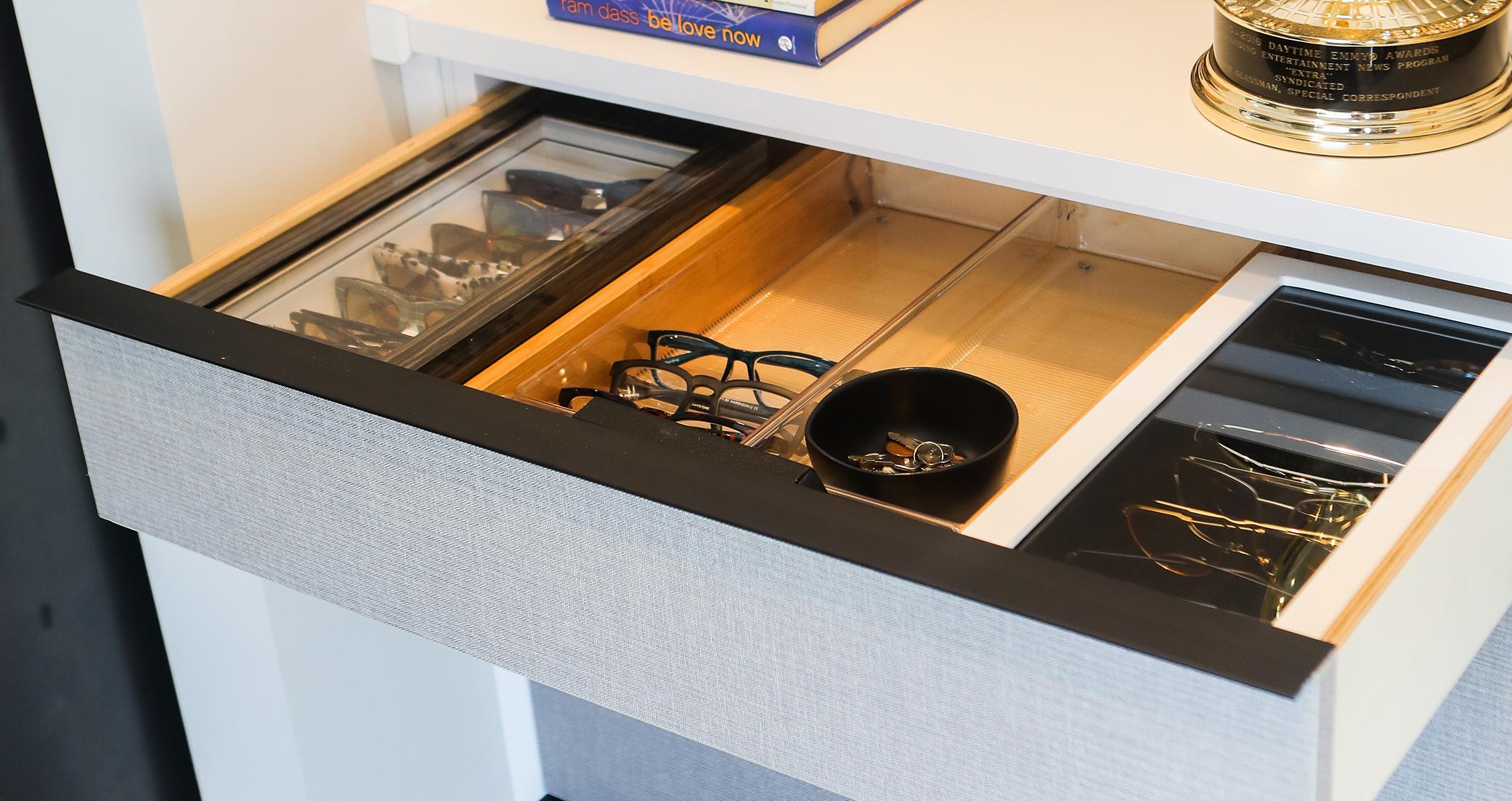 Custom pull out accessory drawer with organizers for sunglasses by California Closets