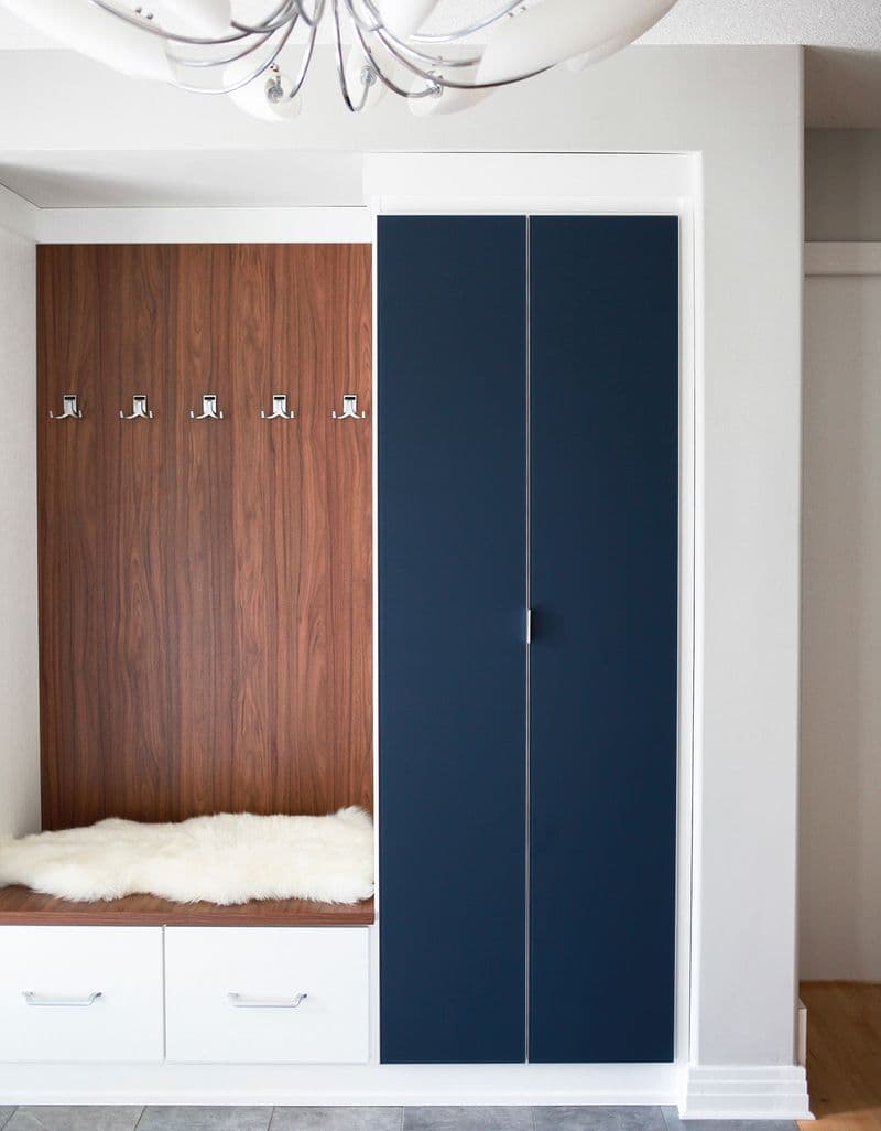 Custom mudroom entry storage cabinets with bench in dark and blue wood finishes California Closets