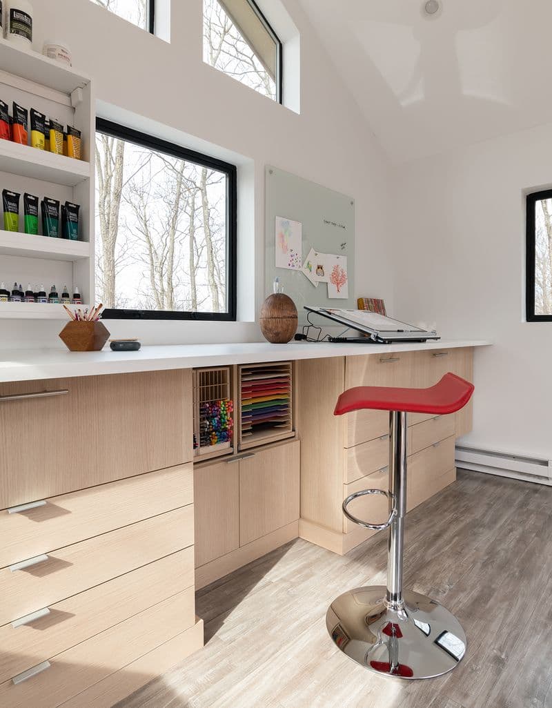 Studio design for a craft artist with custom shelving, drawers and desk by California Closets