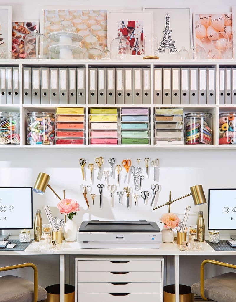 Creative studio designed with custom built in shelving, cubbies and work desk for Darcy Miller by California Closets