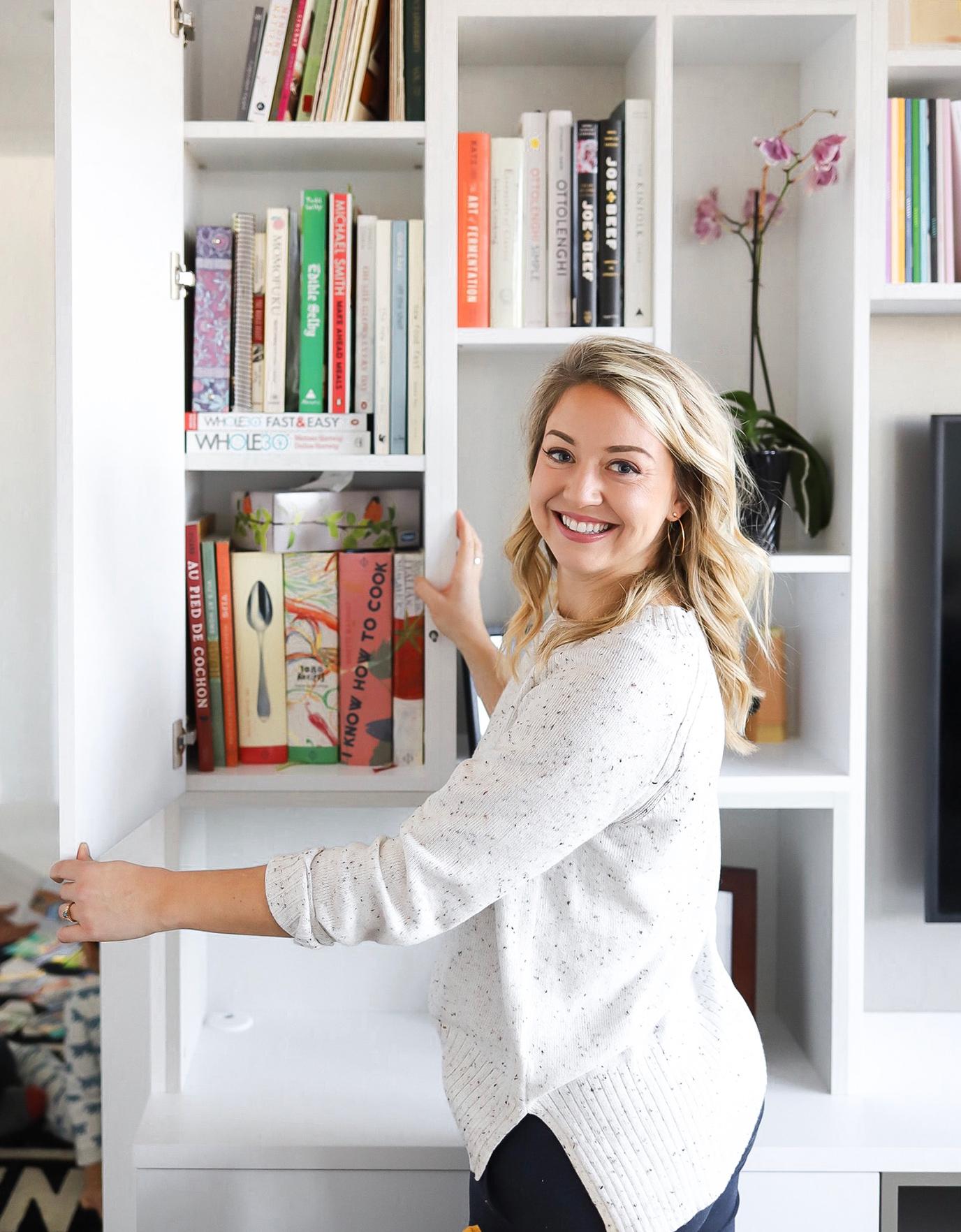 Emma Betty's custom media wall entertainment center shelving in her living room by California Closets