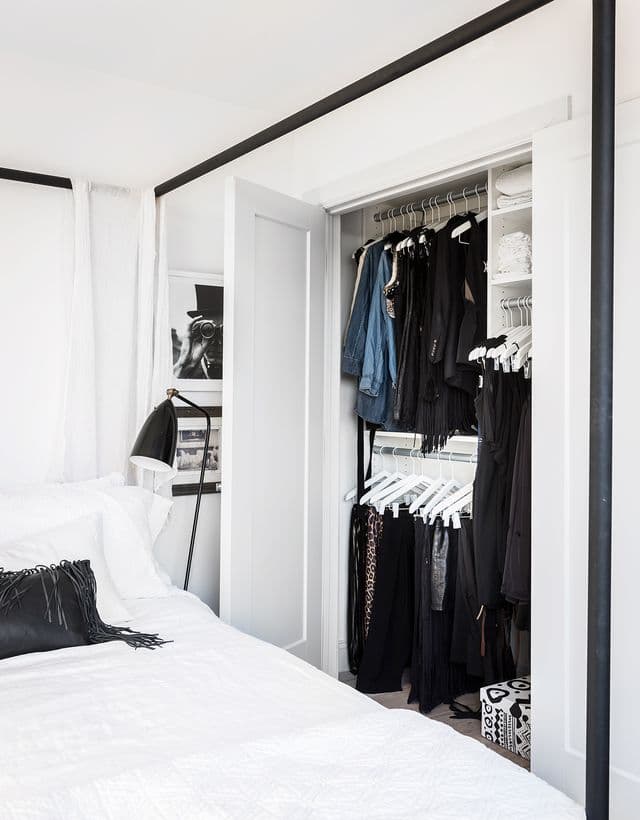 Side view of white organized reach in custom closet for client Erin Swift by California Closets