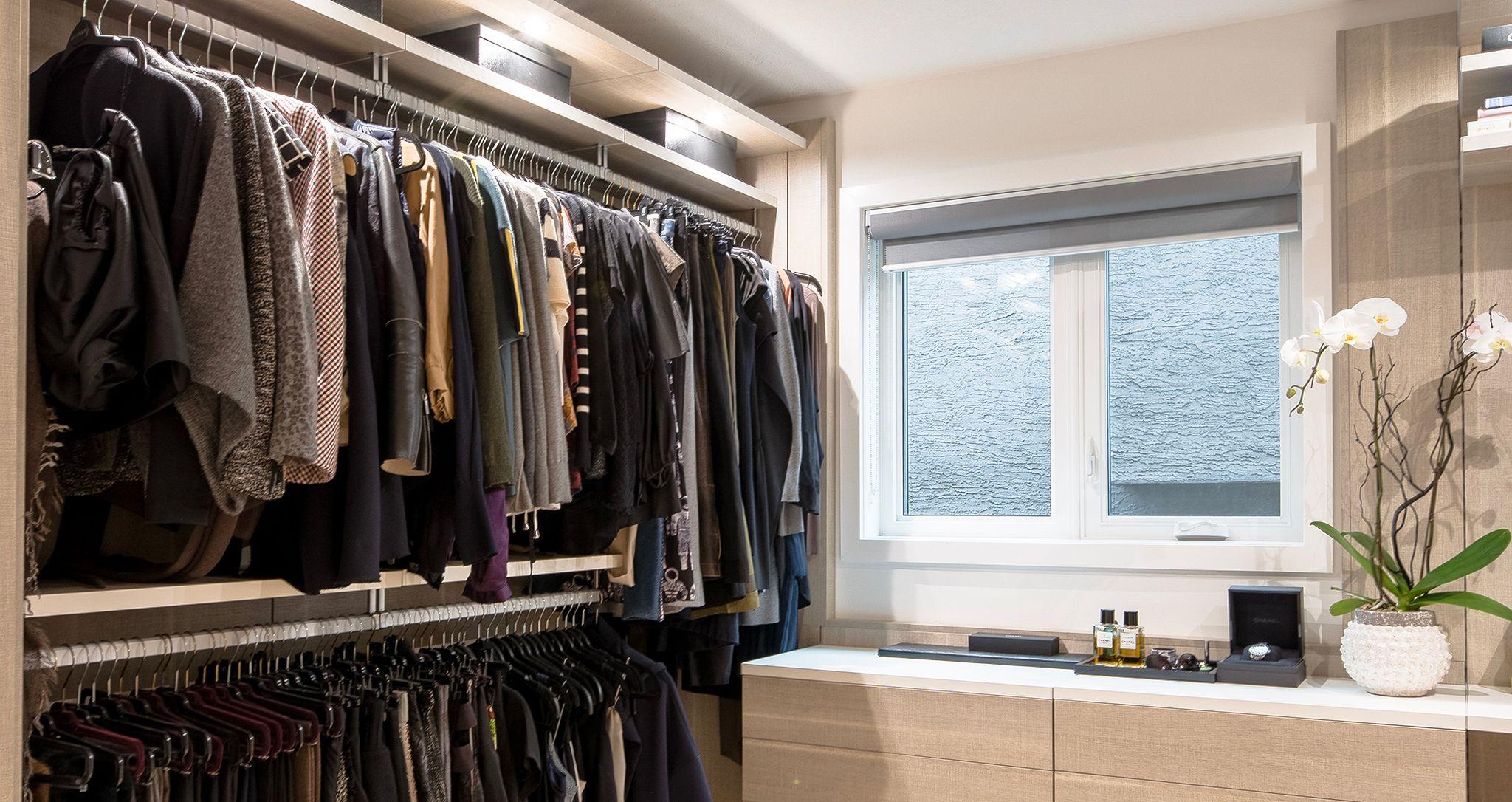 Floating storage cabinets for custom closet in light wood finish and extra wardrobe storage by California Closets