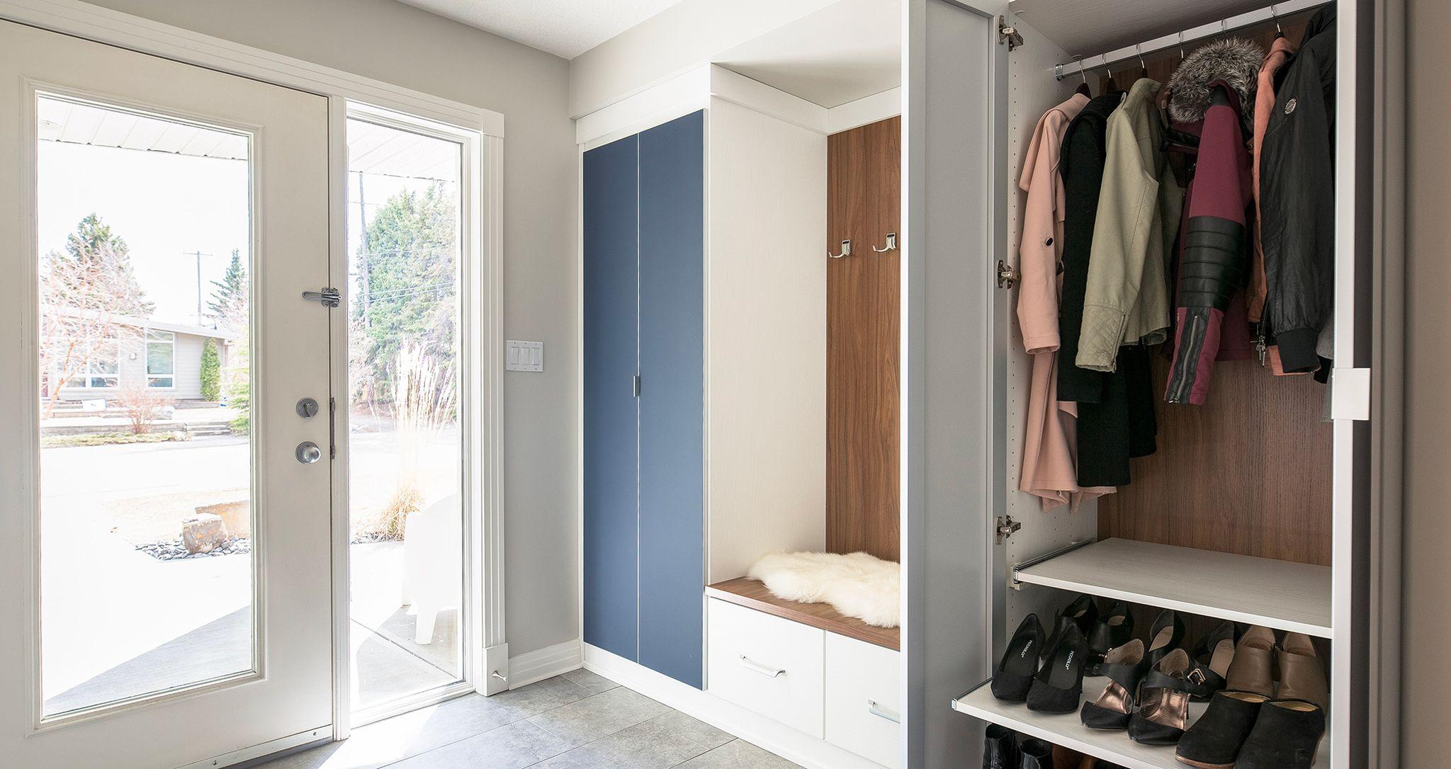 Entryway mudroom storage with shoe shelves and window bench by California Closets