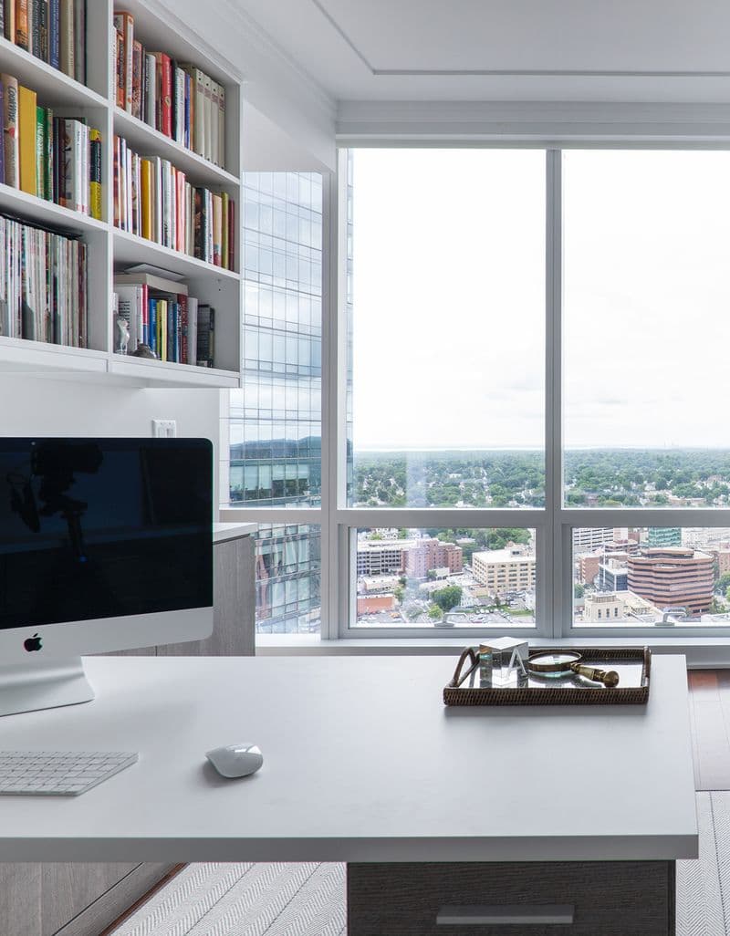 A custom home office with view, built in cabinets, shelving, desk and drawers by California Closets