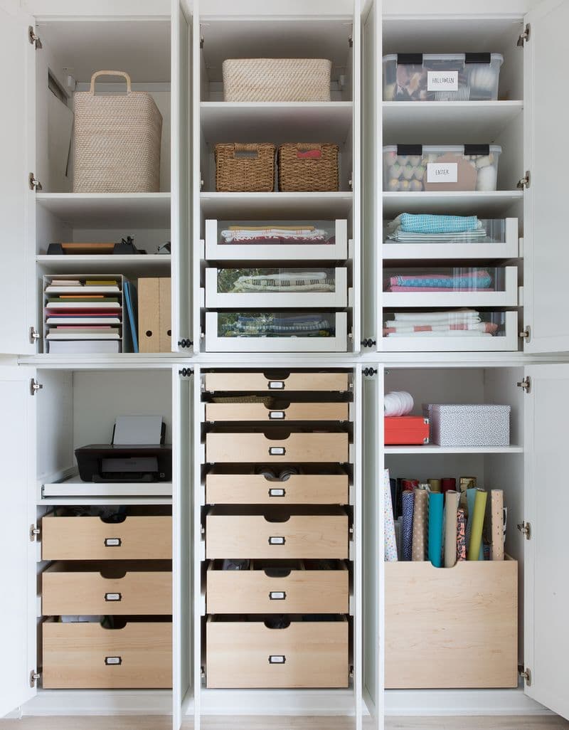 Open shelving and cubbies holding craft supplies and storage of materials and finishes by California Closets