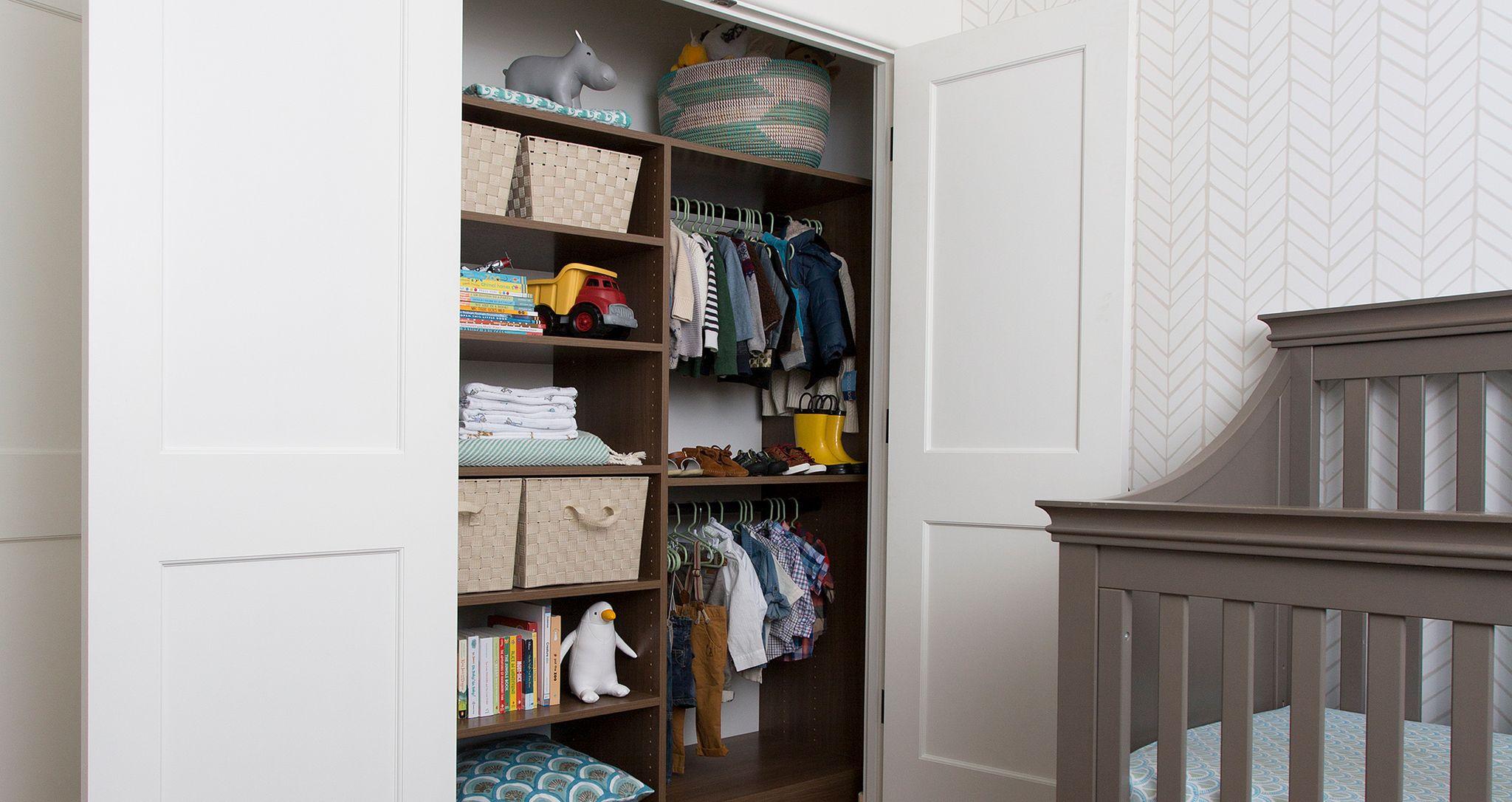 Reach in closet for kids with cubbies, baskets, shelving, dark finish California Closets