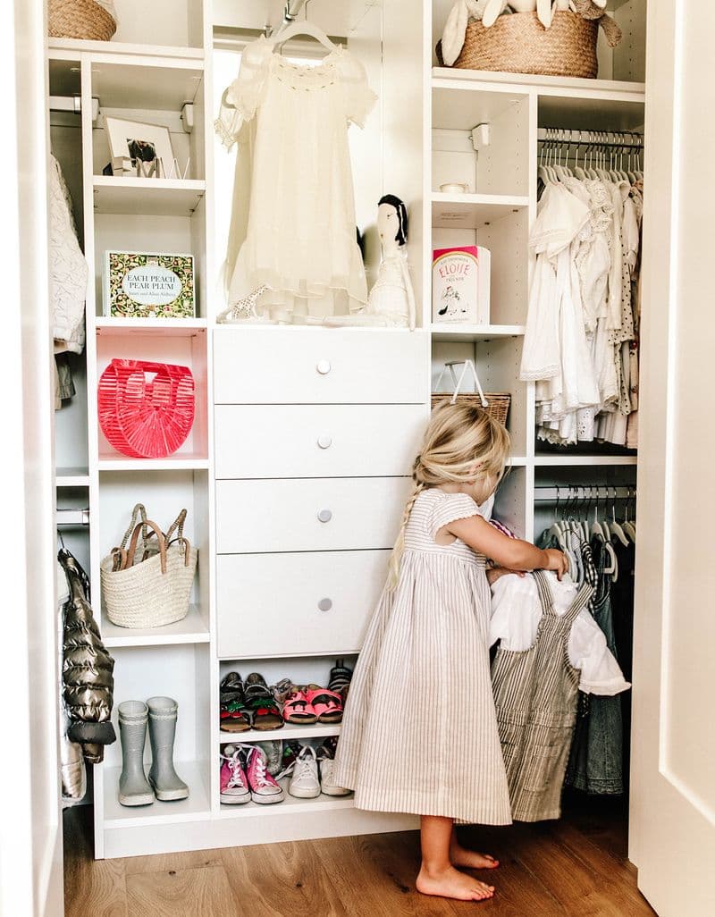 Reach-in kid's closet with built in dresser drawers, shoe shelves and cubbies by California Closets