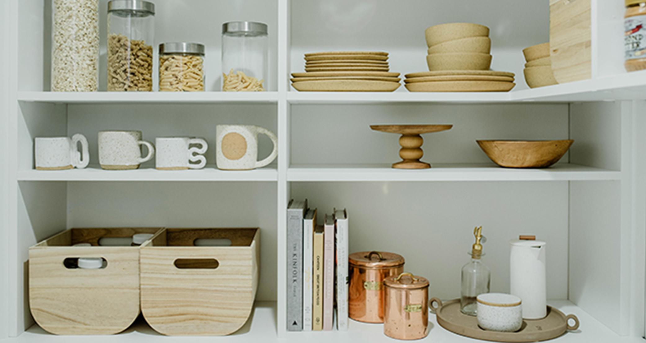 Organized white pantry shelves for interior designer Sarah Sherman Samuel by California Closets