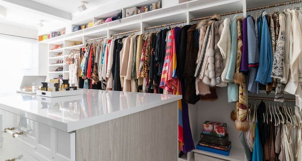 Center island storage drawers and open shelving for Susan Magrino's closet by California Closets