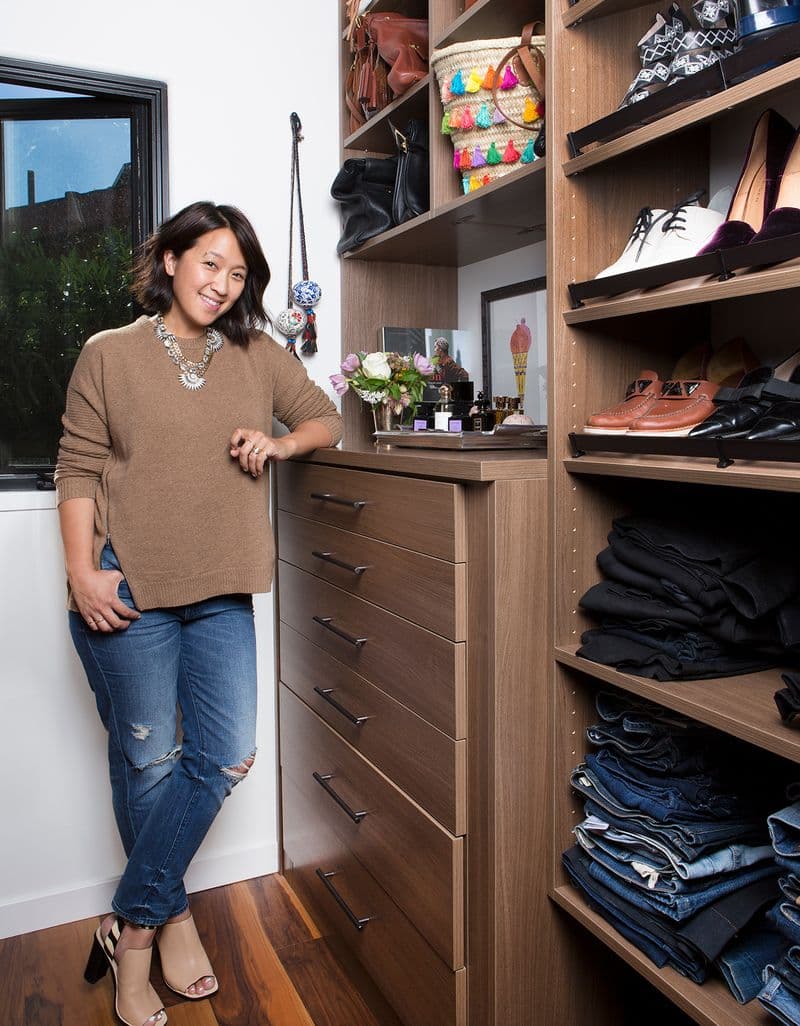 Custom built in dresser and shelving in walk in closet in dark wood finish by California Closets