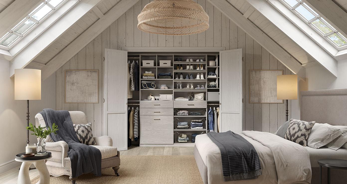 Attic bedroom style with large reach in closet with custom shoe and wardrobe storage by California Closets