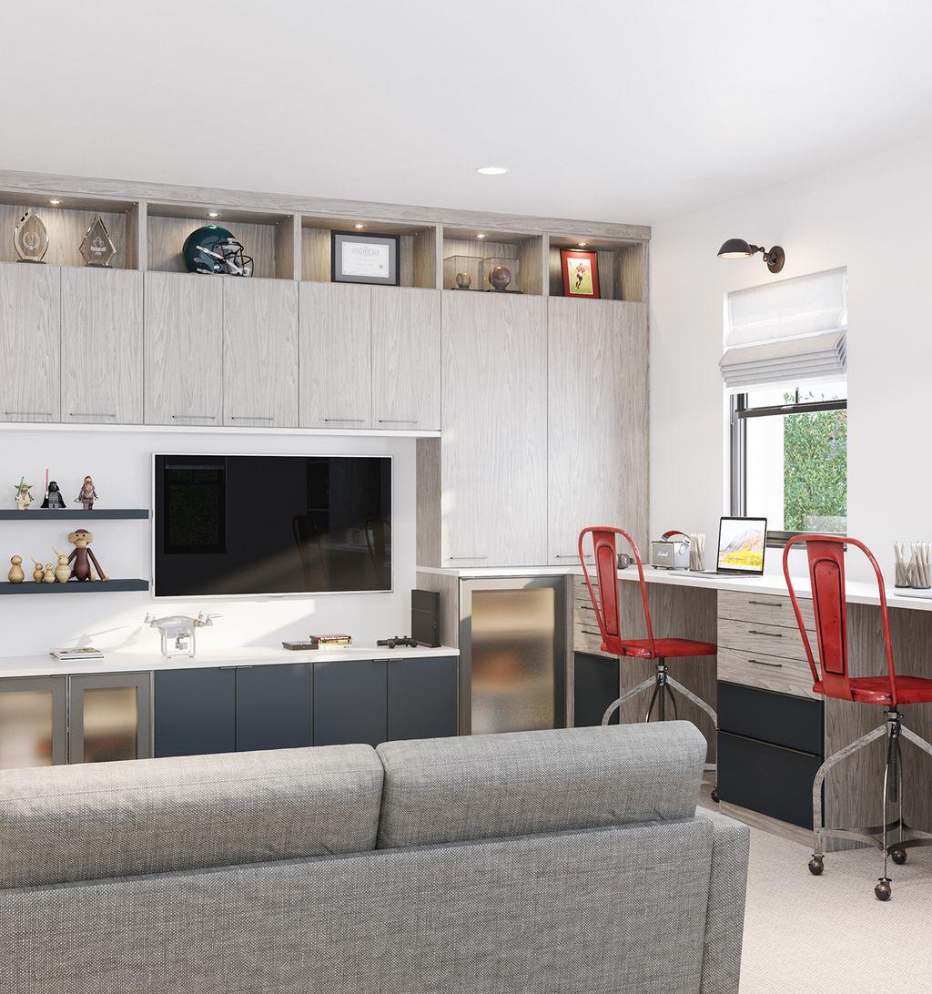 Espacio de trabajo de sala familiar con centro de entretenimiento, gabinetes de madera clara, estantes e iluminación personalizada de California Closets