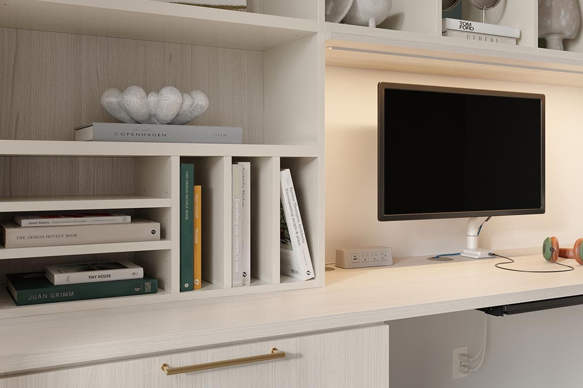 Custom shelf dividers built in to the wall above desk from California Closets