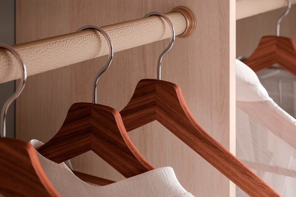 Round leather-wrapped closet hanging rod with wooden hangers by California Closets