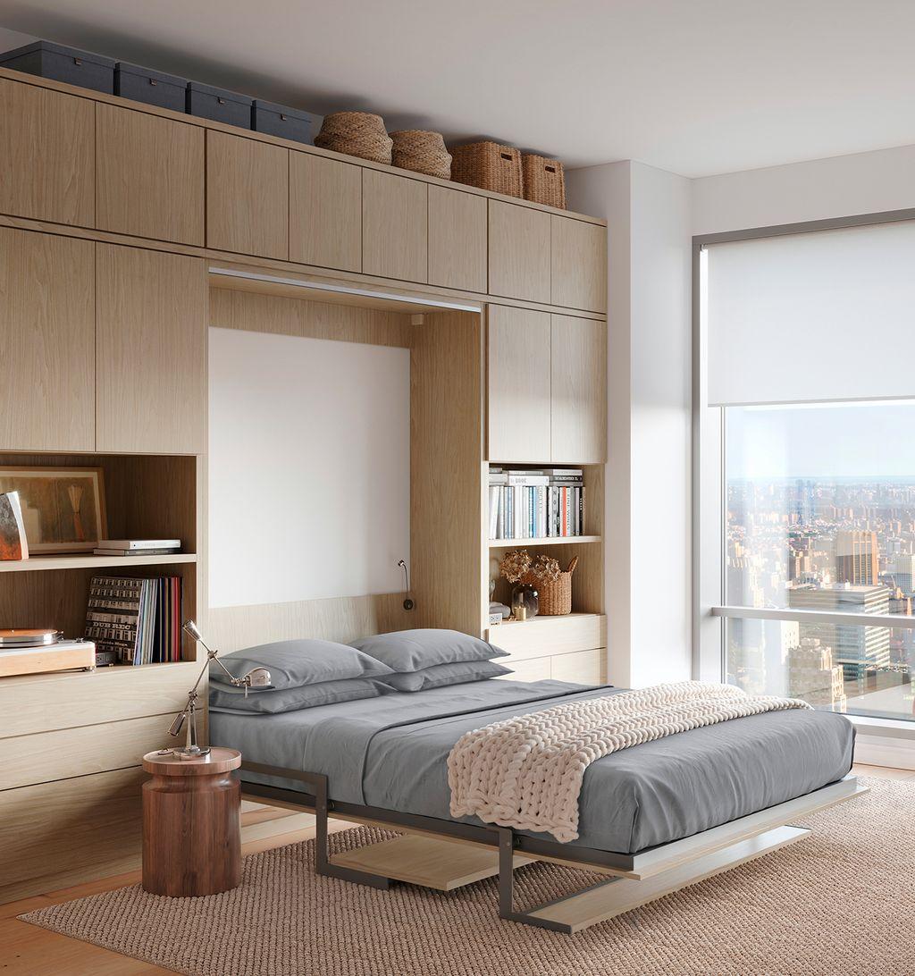 Hidden bed and storage with custom cabinetry in natural finish by California Closets