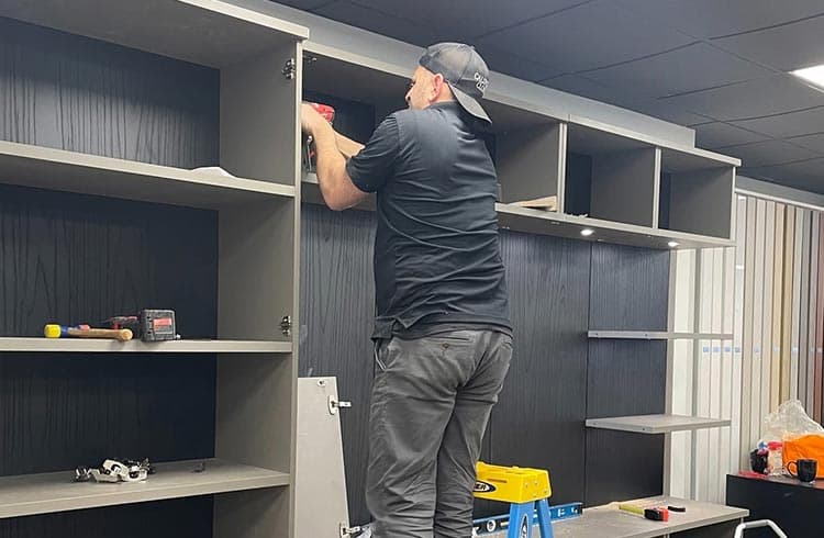 Installer technician working on adding custom-built shelving from California Closets