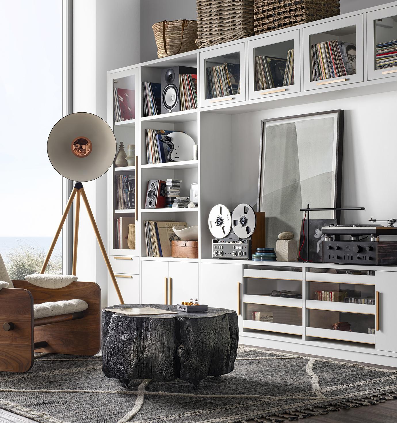 Sala de estar estilo loft con gabinetes de almacenamiento tipo centro de entretenimiento de California Closets