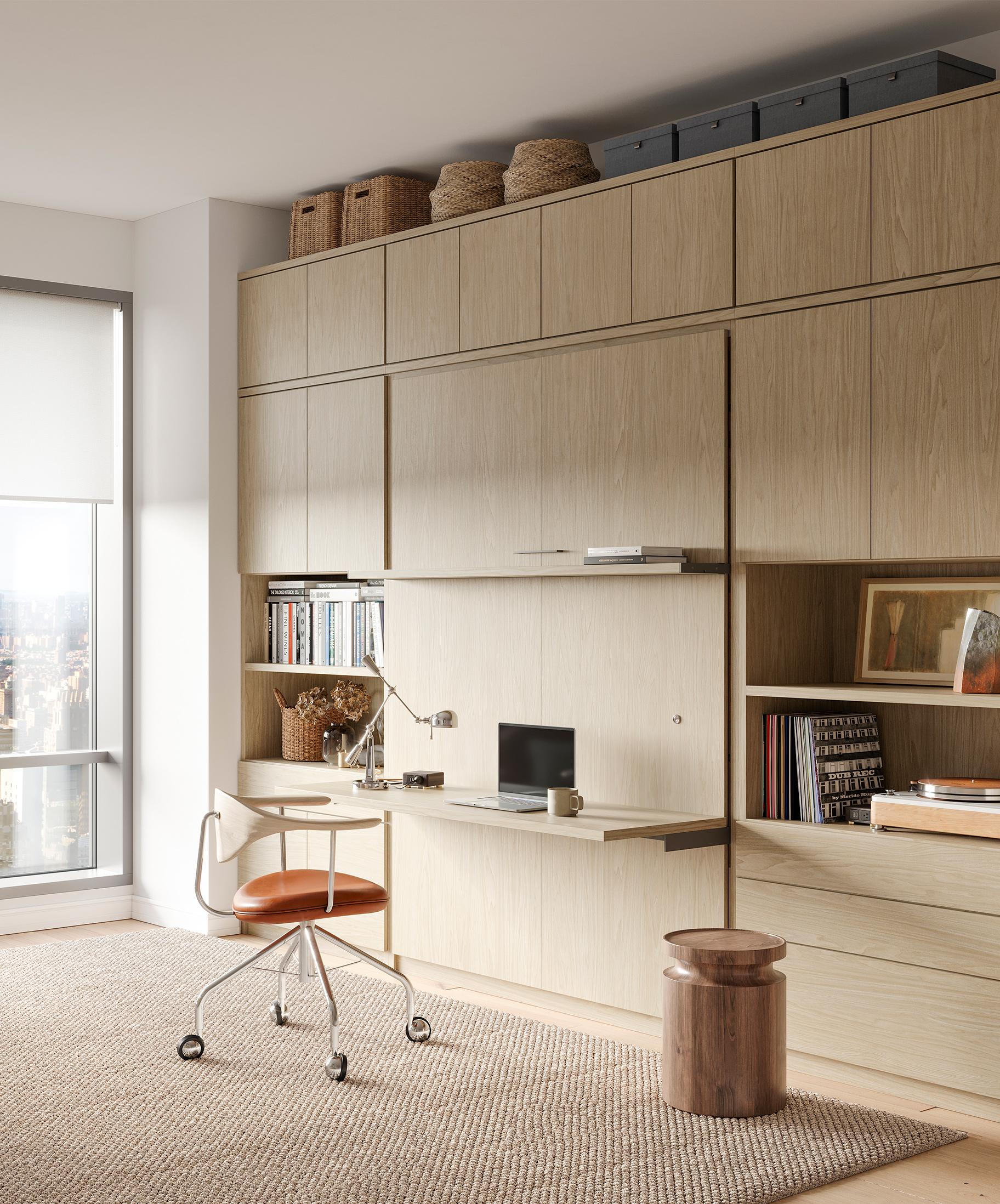 Murphy bed designed in a natural wood finish with office desk designed by California Closets