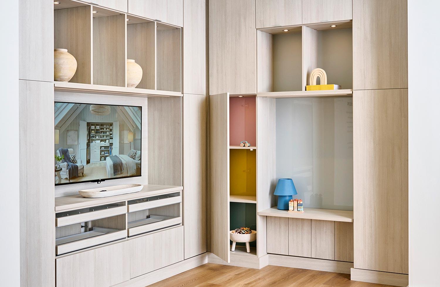 Customized entertainment center with built in cabinets floor to ceiling by California Closets