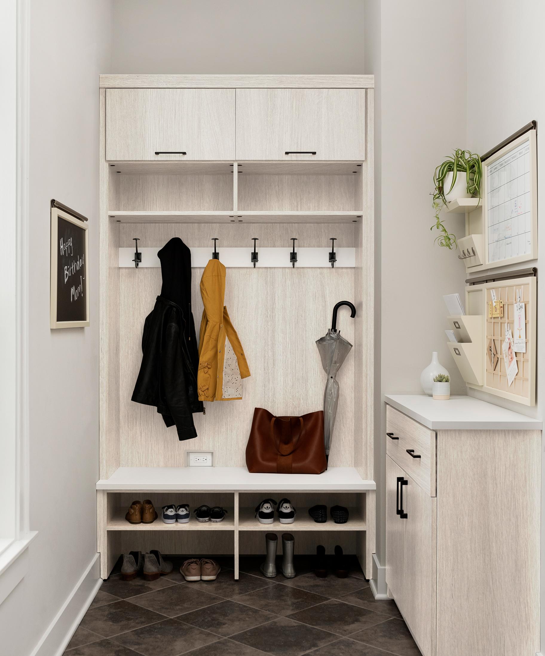 Custom grey mudroom design ideas with closed drawers and storage cabinets by California Closets