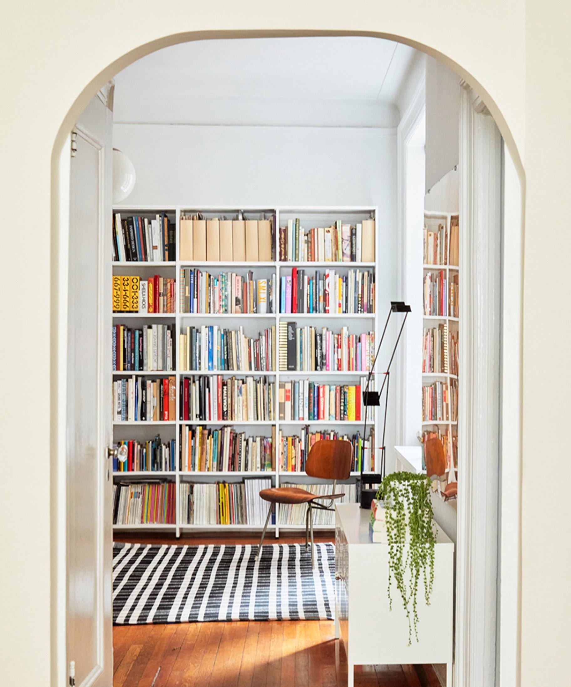 Hallway library bookshelves in classic white finisy by Calfornia Closets