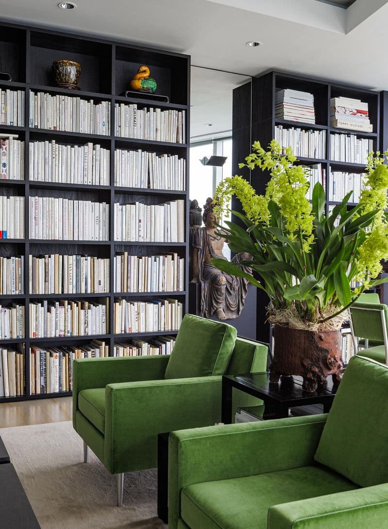 Gallery styled living room with custom black finish bookshelves from California Closets