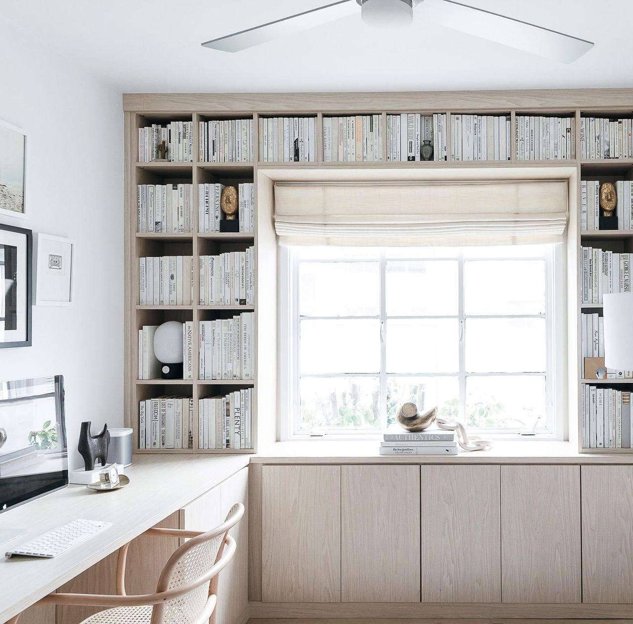 Bookshelves built in to nursery with a home office by California Closets