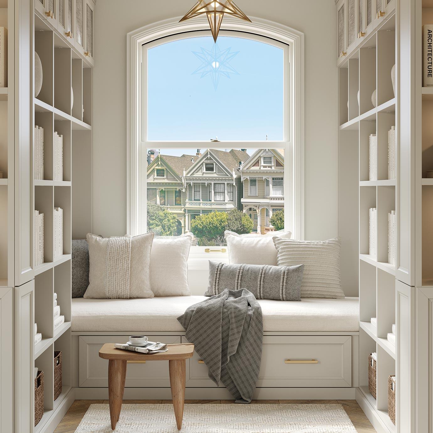 Espacio de lectura de biblioteca personalizado, área de banco junto a la ventana con estanterías de California Closets