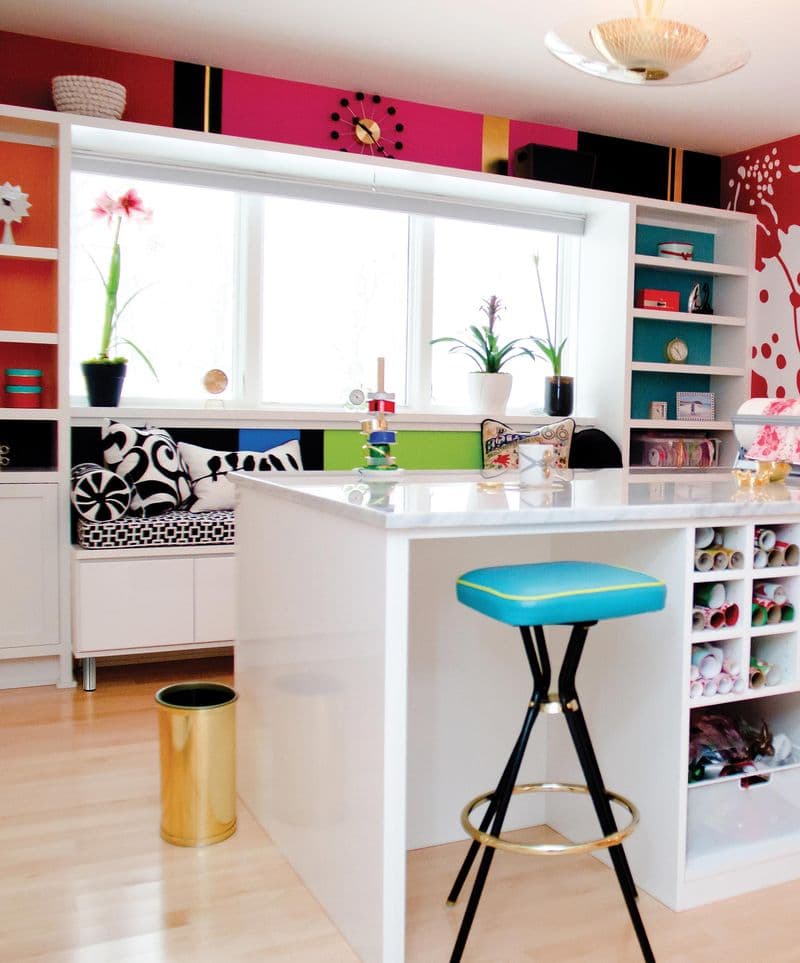 Colorfully-designed crafting space with high top desk work counter and custom shelving by California Closets