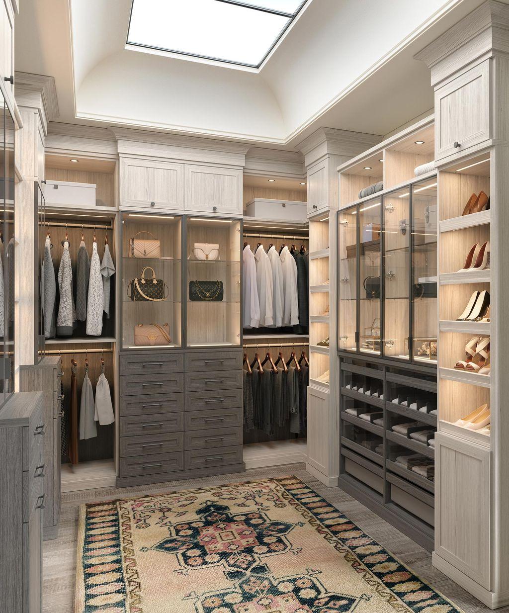 Hers custom walk in closet with clear glass doors and crown molding details by California Closets