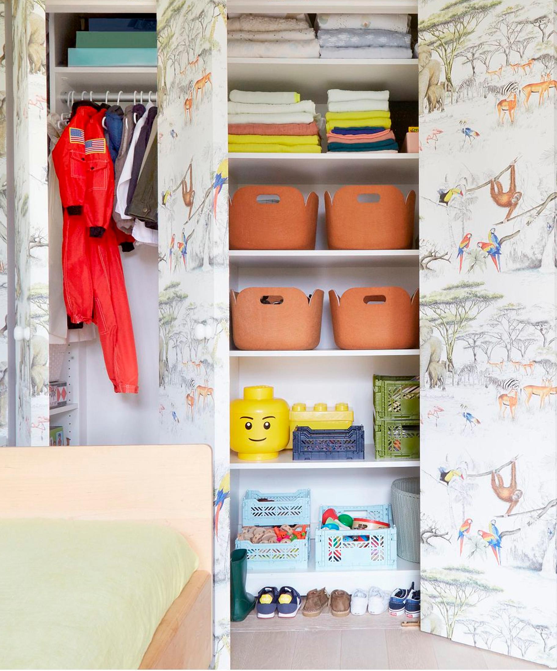 Custom wallpapered reach in closet design by California Closets