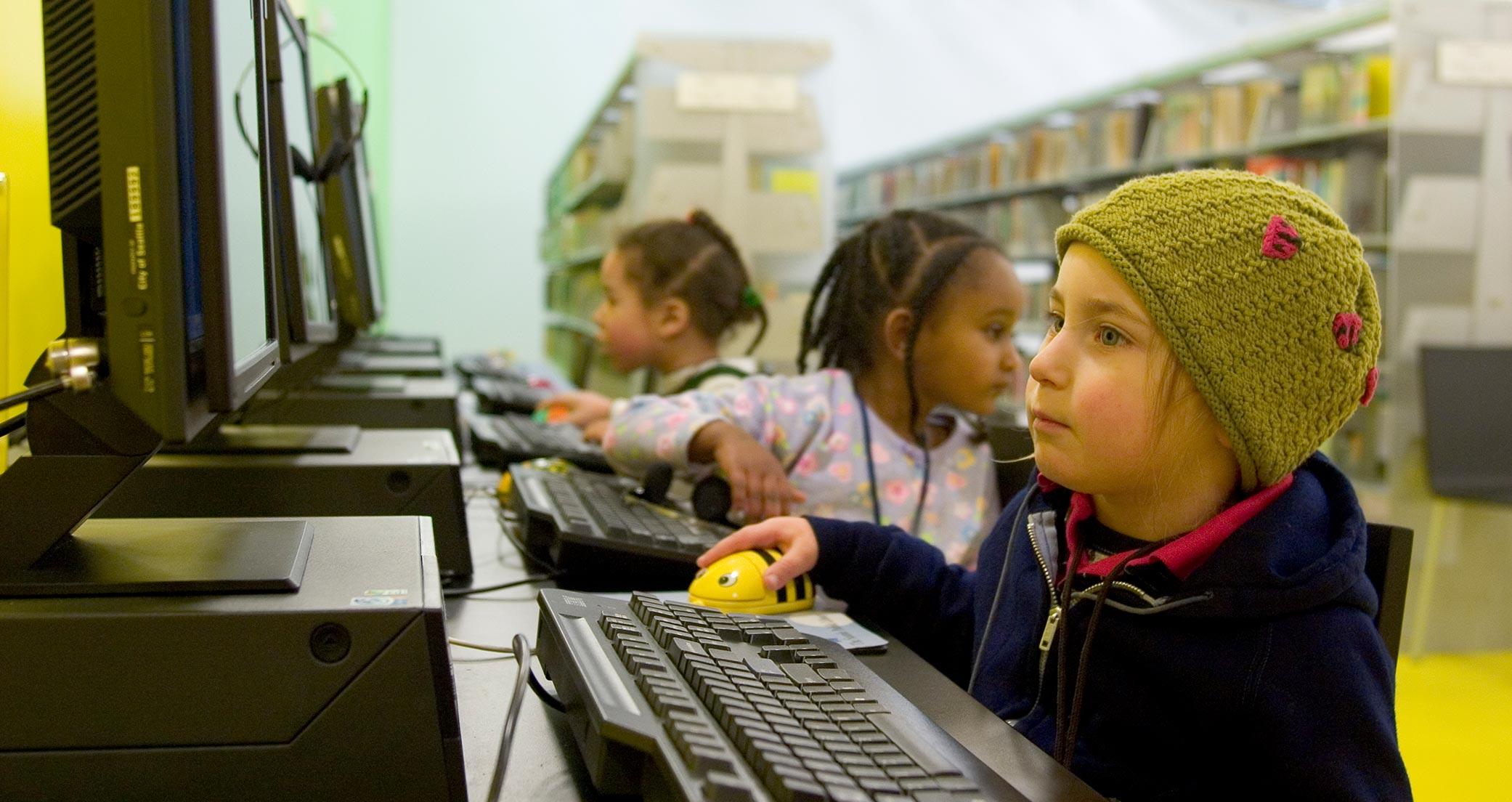 Kids on computers at the high end design Seattle Library as featured in Ideas of Order Magazine
