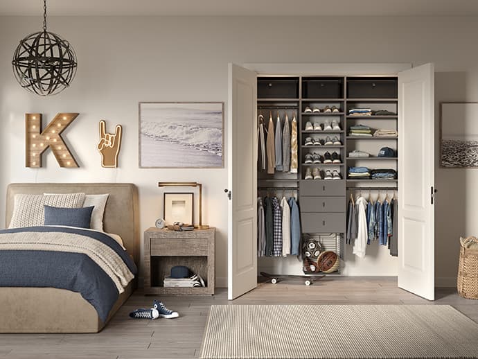 Custom kids closet with shoe storage, shelving, and drawers in a gray finish by California Closets