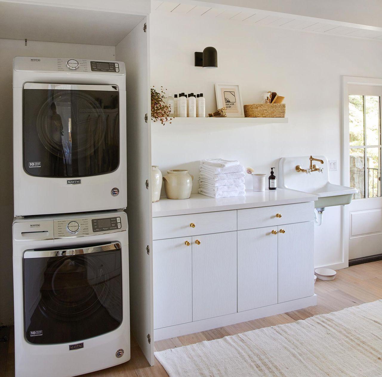 Laundry small space storage stacked next to custom cabinets and counter by California Closets