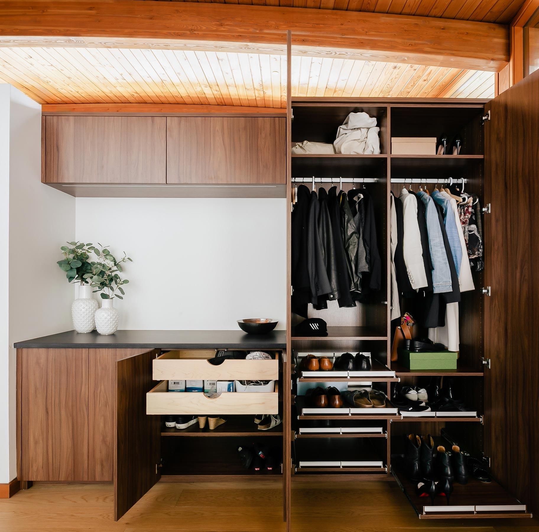 Modern mid-century designed home closet in dark wood finish by California Closets