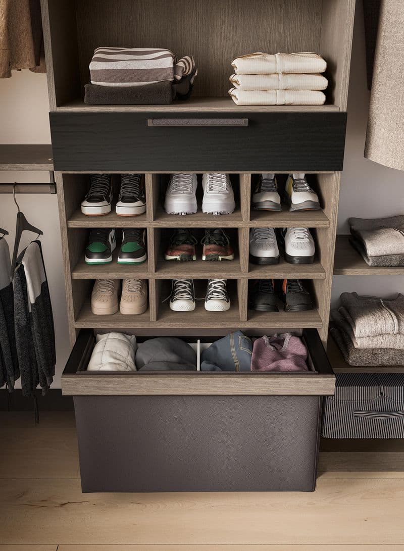 Organizing cubbies in walk in closet designed for shoe storage by California Closets