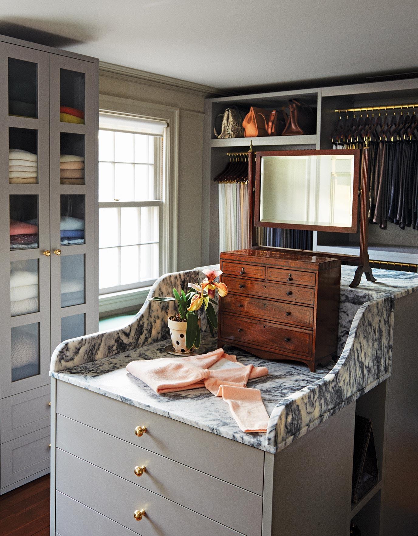 Martha Stewart's two-sided bureau topped with marble provides space for a clothes-folding station in Ideas of Order Magazine